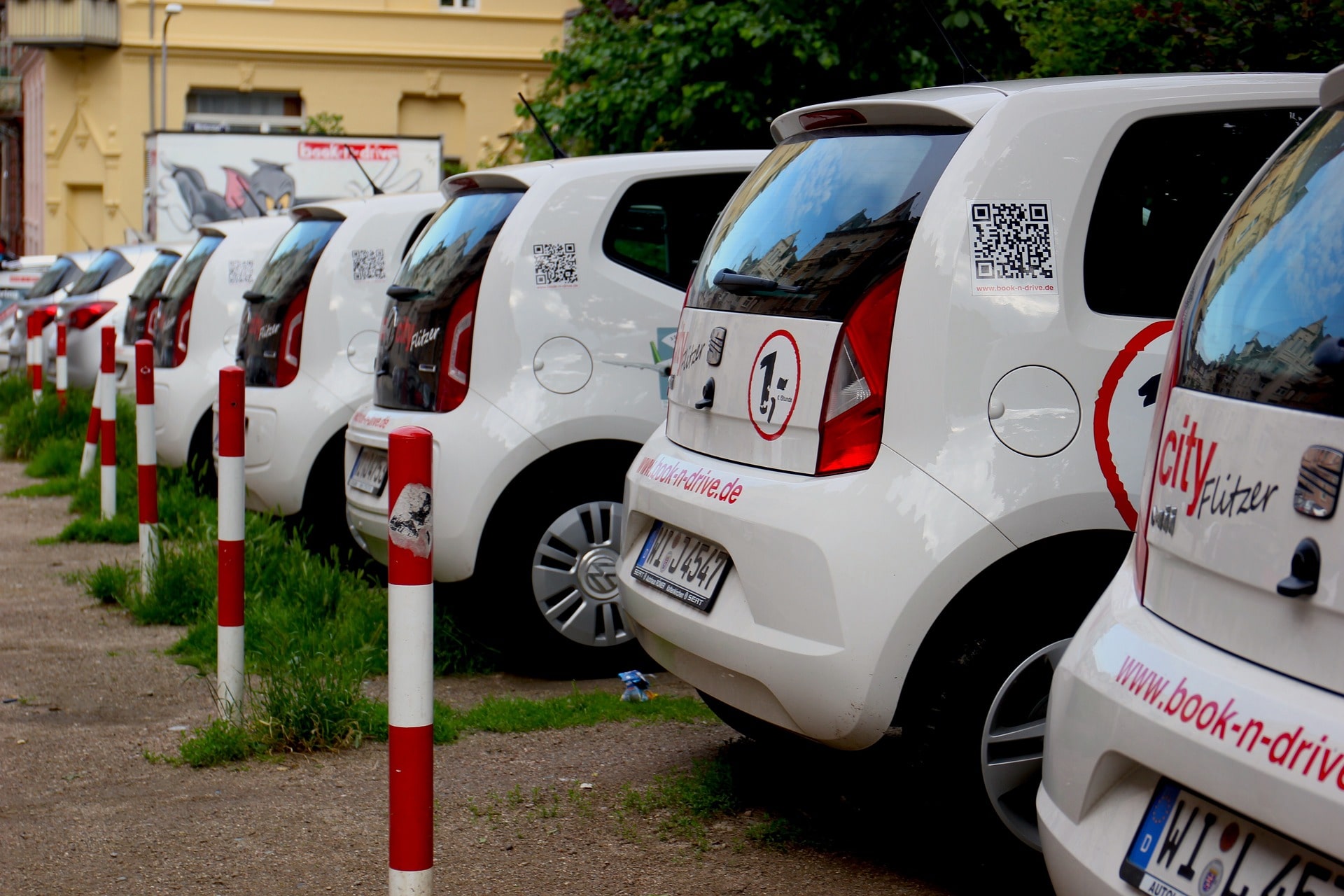 Rental car driving through Tirana city streets with mountains in the background – perfect for travelers exploring Albania