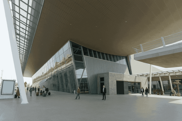 Tirana International Airport entrance with rental car pickup area.